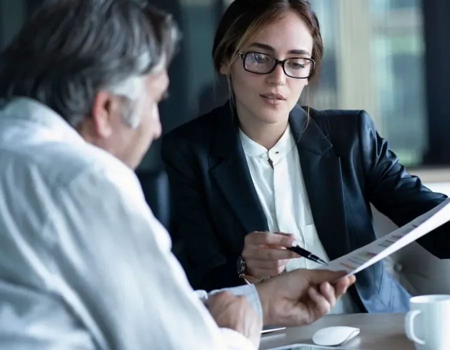 Accountant in meeting with client reviewing balance sheet